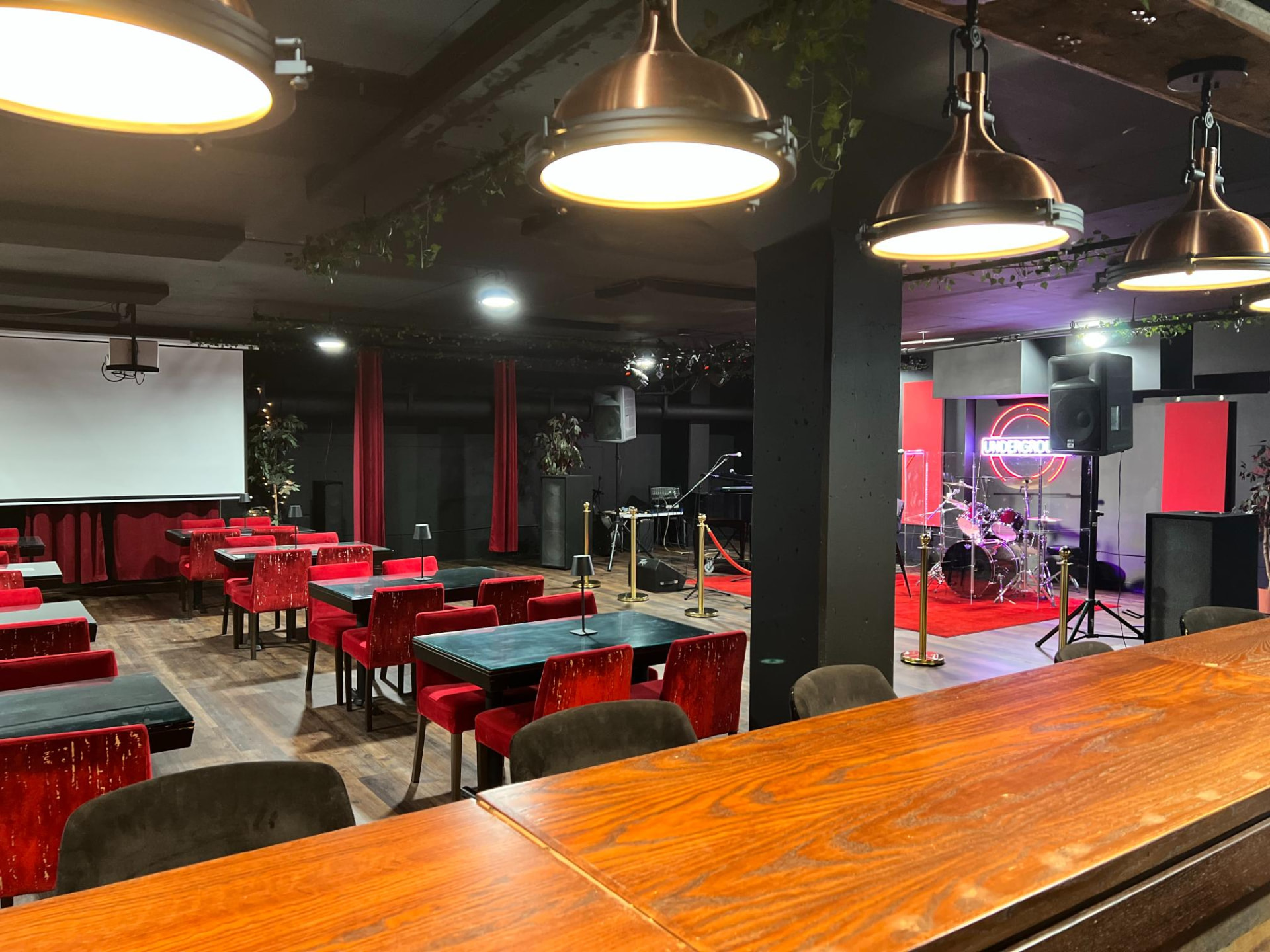Stage, projector and cabaret seating viewed from the bar