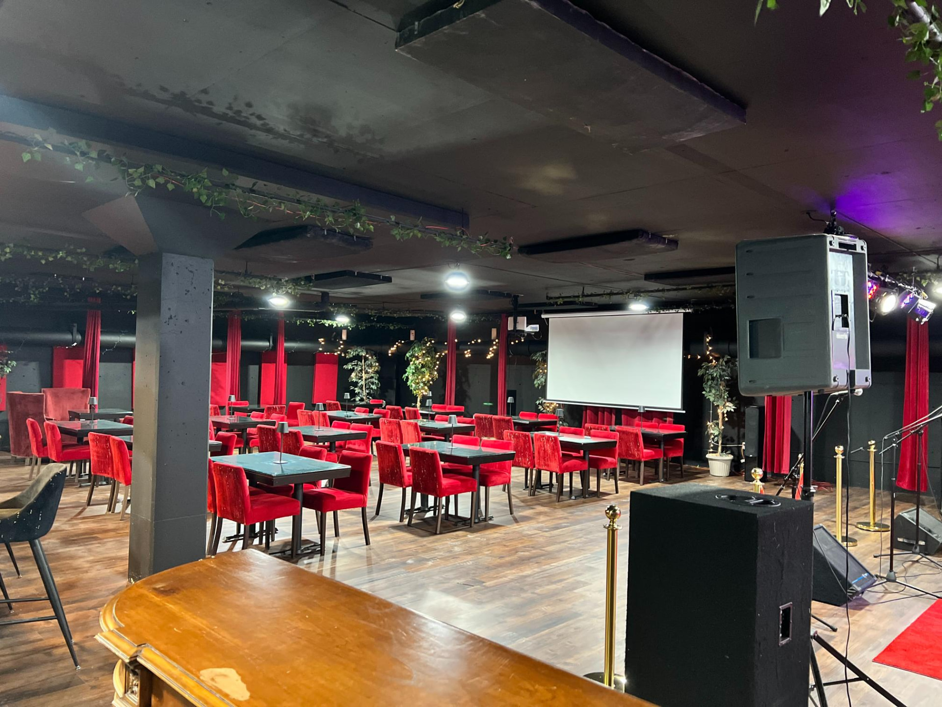 Main theatre arranged with tables, projector and stage sound